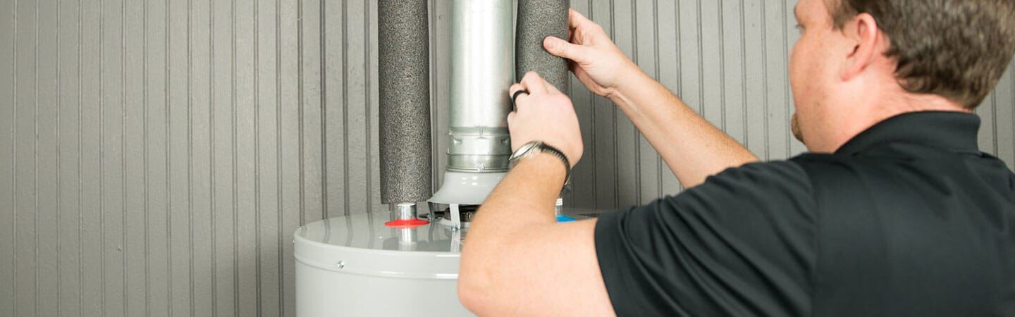 man working on water heater
