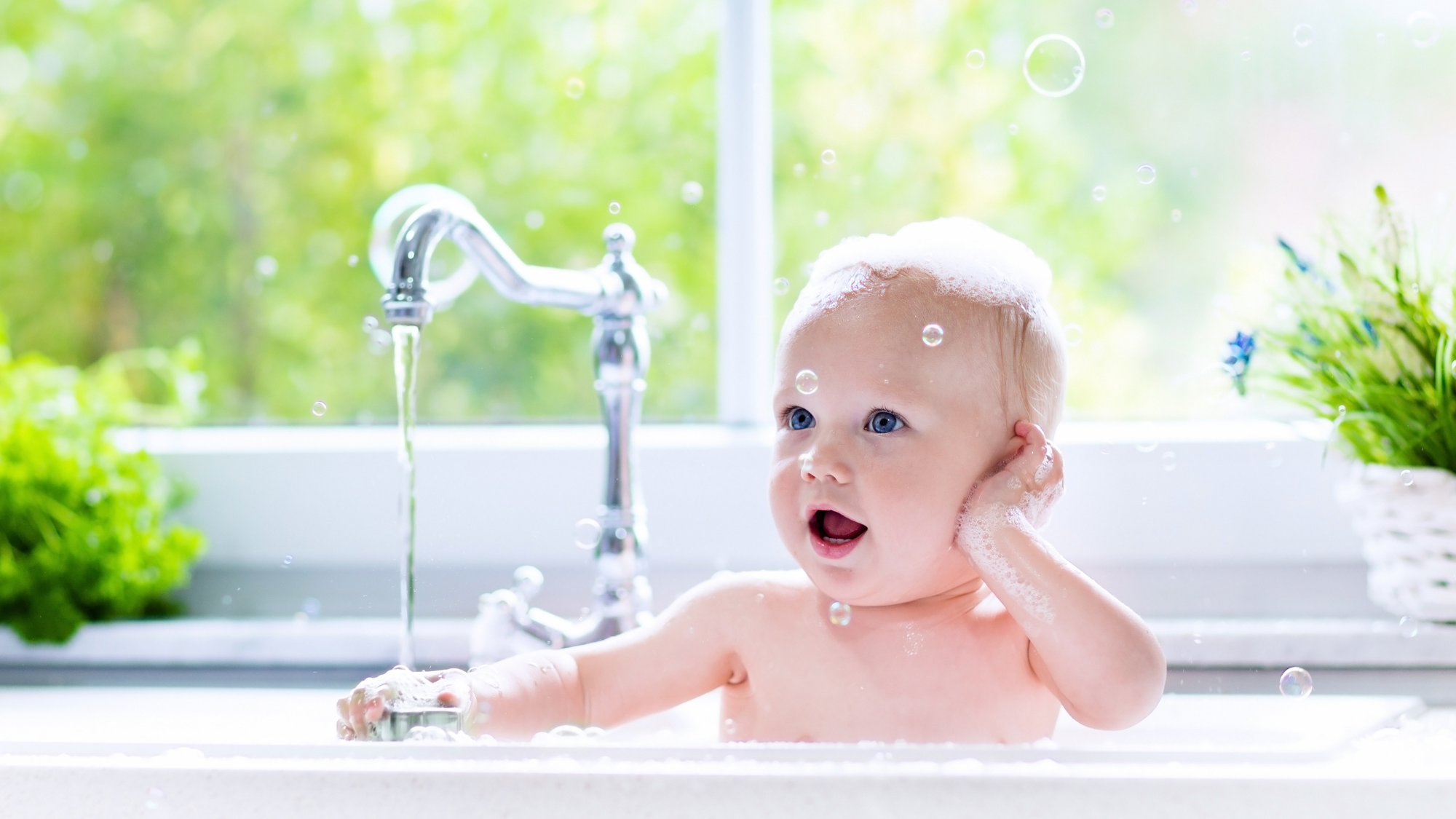 baby in sink getting a bath